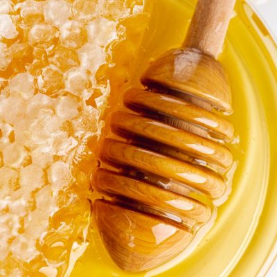 close-up-honeycomb-with-wooden-dipper close-up-honeycomb-with-wooden-dipper
